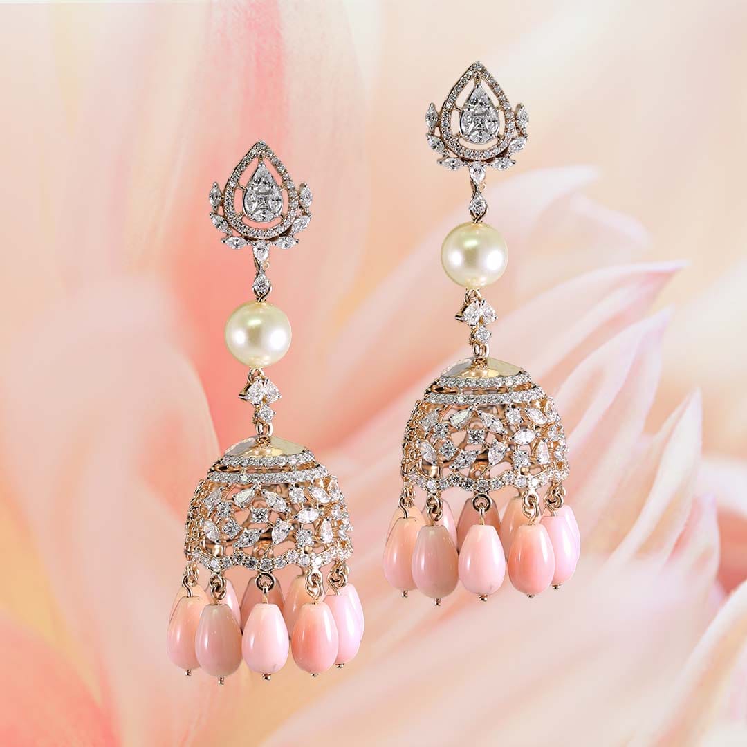 Diamond earrings with pearl and peach color stones give a dazzling look.