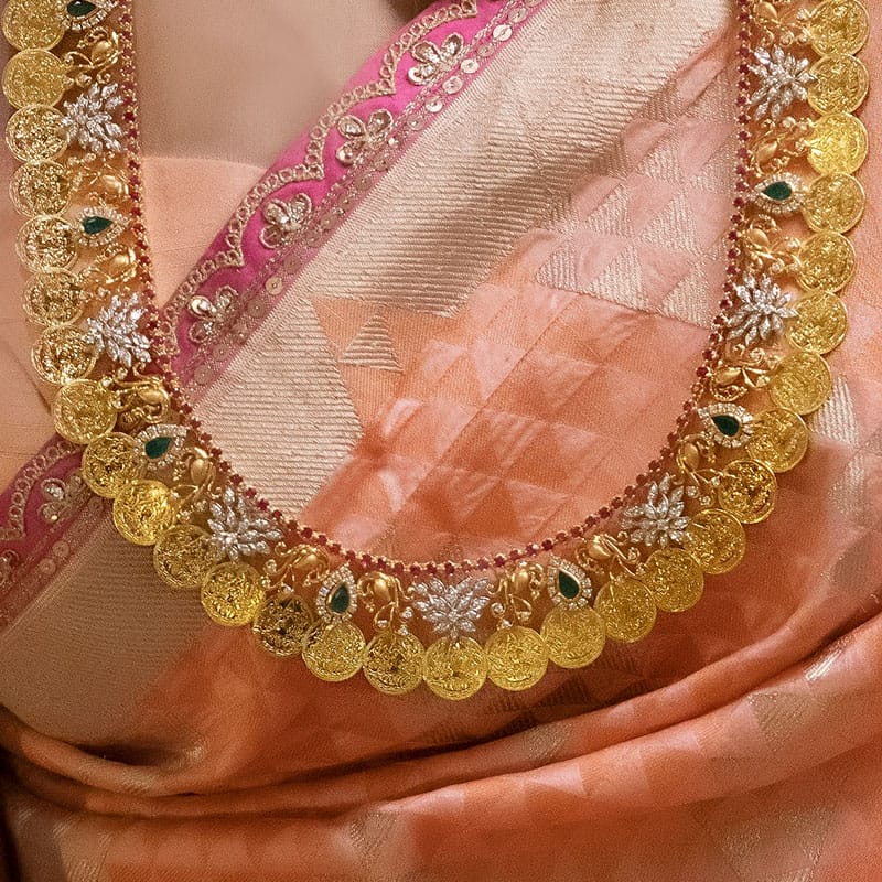 Traditional South-Indian kaasu malai studded with diamonds and gemstones.