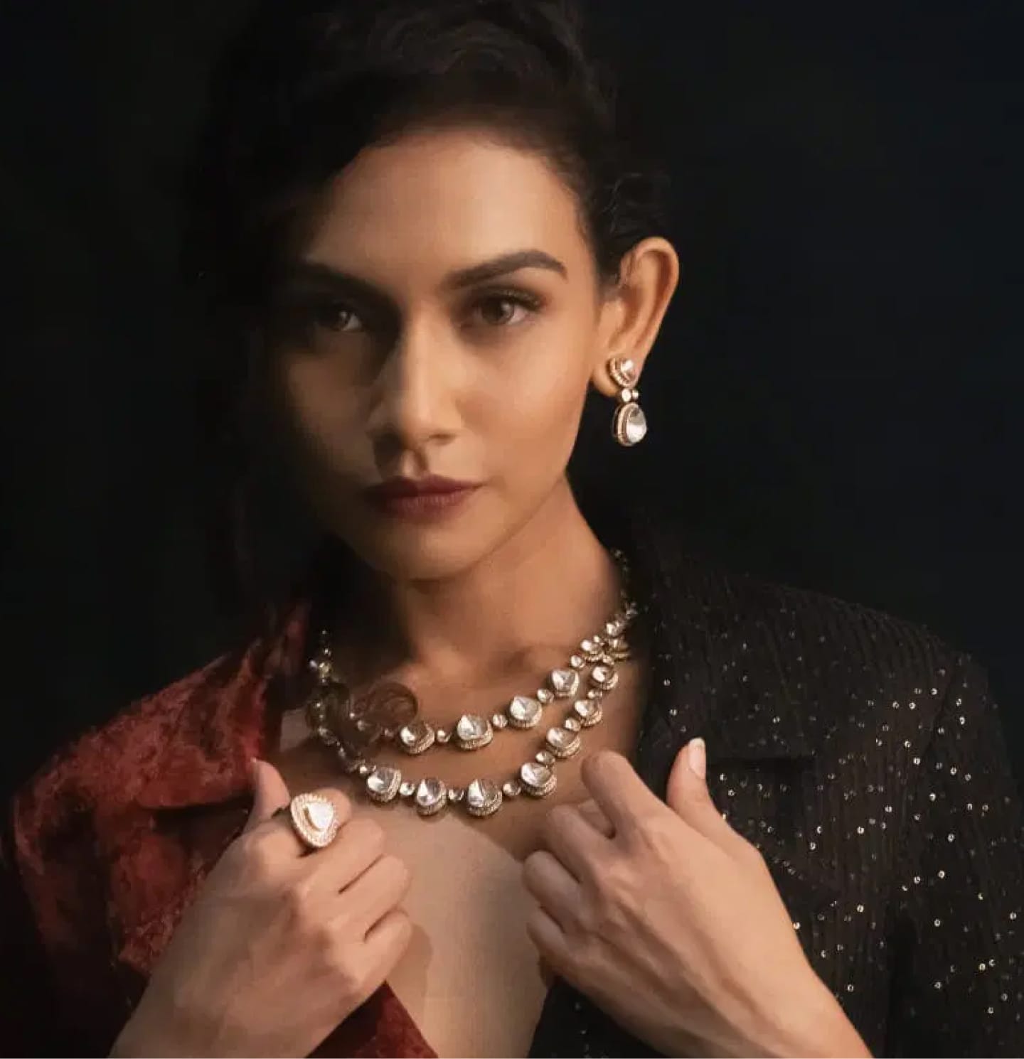 A close-up shot of a modern maid in a Western outfit wearing uncut layered diamond polki jewellery with from the Fazza Collection by Khwaahish.