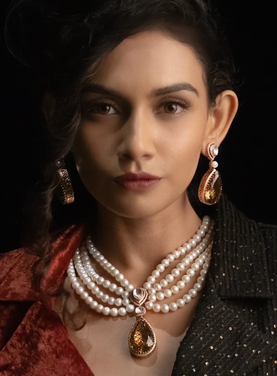 A close-up shot of a modern maid in a Western outfit wearing uncut diamond polki jewellery with pearls and precious gemstones from the Fazza Collection by Khwaahish.