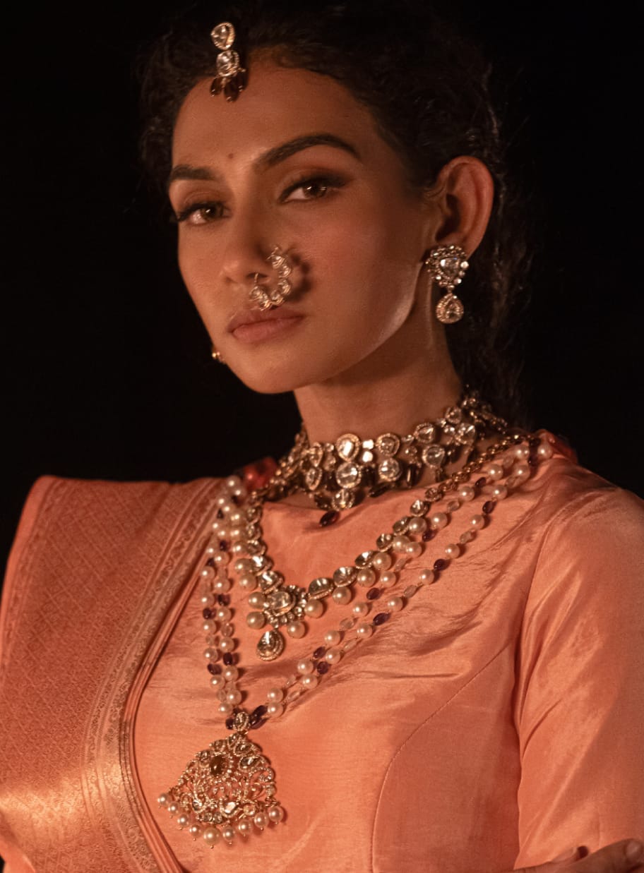 A close-up shot of a modern maid wearing uncut diamond heritage polki jewellery with pearls and precious gemstones from the Fazza Collection by Khwaahish.